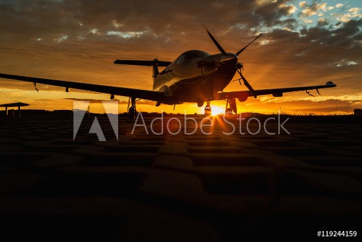 Picture of Single turboprop aircraft on runway at sunset time